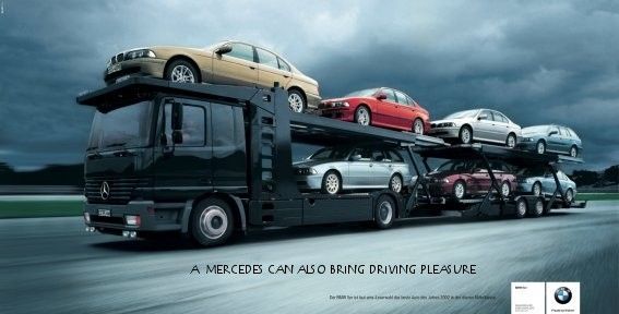 Слоган на плакате, Мерседес тоже может получать удовольствие от вождения. Собственно грузовик Мерседес везёт автомобили BMW.