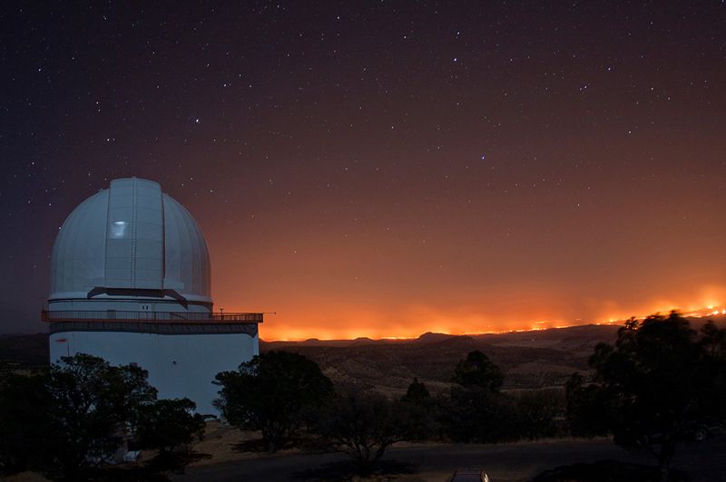  Фото пожара в Рок Хаус, сделанное из обсерватории МакДональда в Дэвис Маунтинс 9 апреля. Фото было сделано с подиума 2,1-метрового телескопа Отто Струва, выходящего на восток. Слева расположен 2,7-метровый телескоп Харлана Дж. Смита. (Frank Cianciolo/McDonald Observatory)