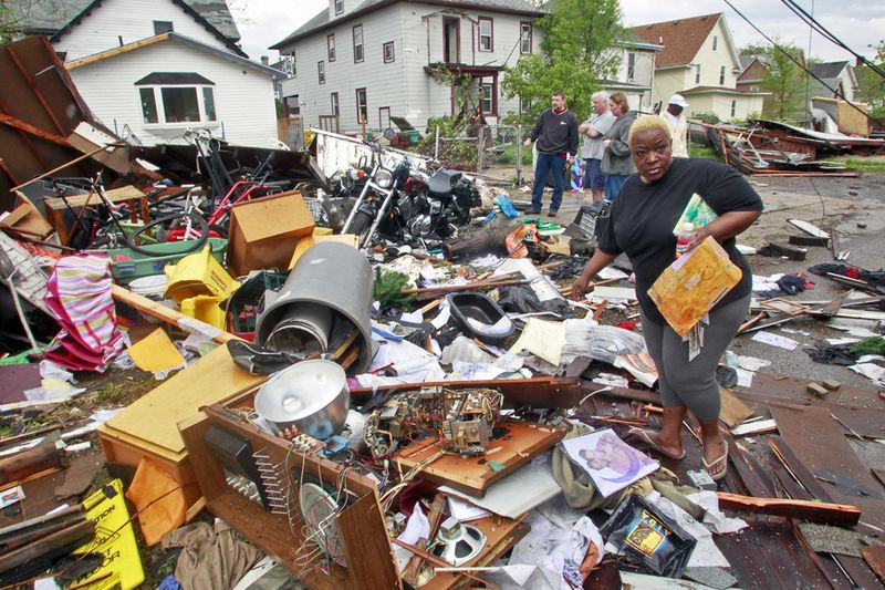  Рэйчел Херст собирает уцелевшие вещи из разрушенного торнадо гаража в Миннеаполисе. (Marlin Levison/The Star Tribune/AP)